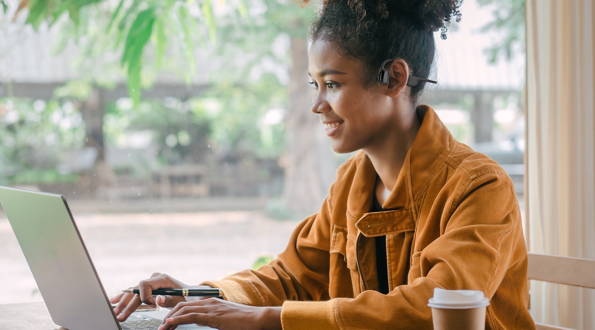 Woman working on laptop using Swym+